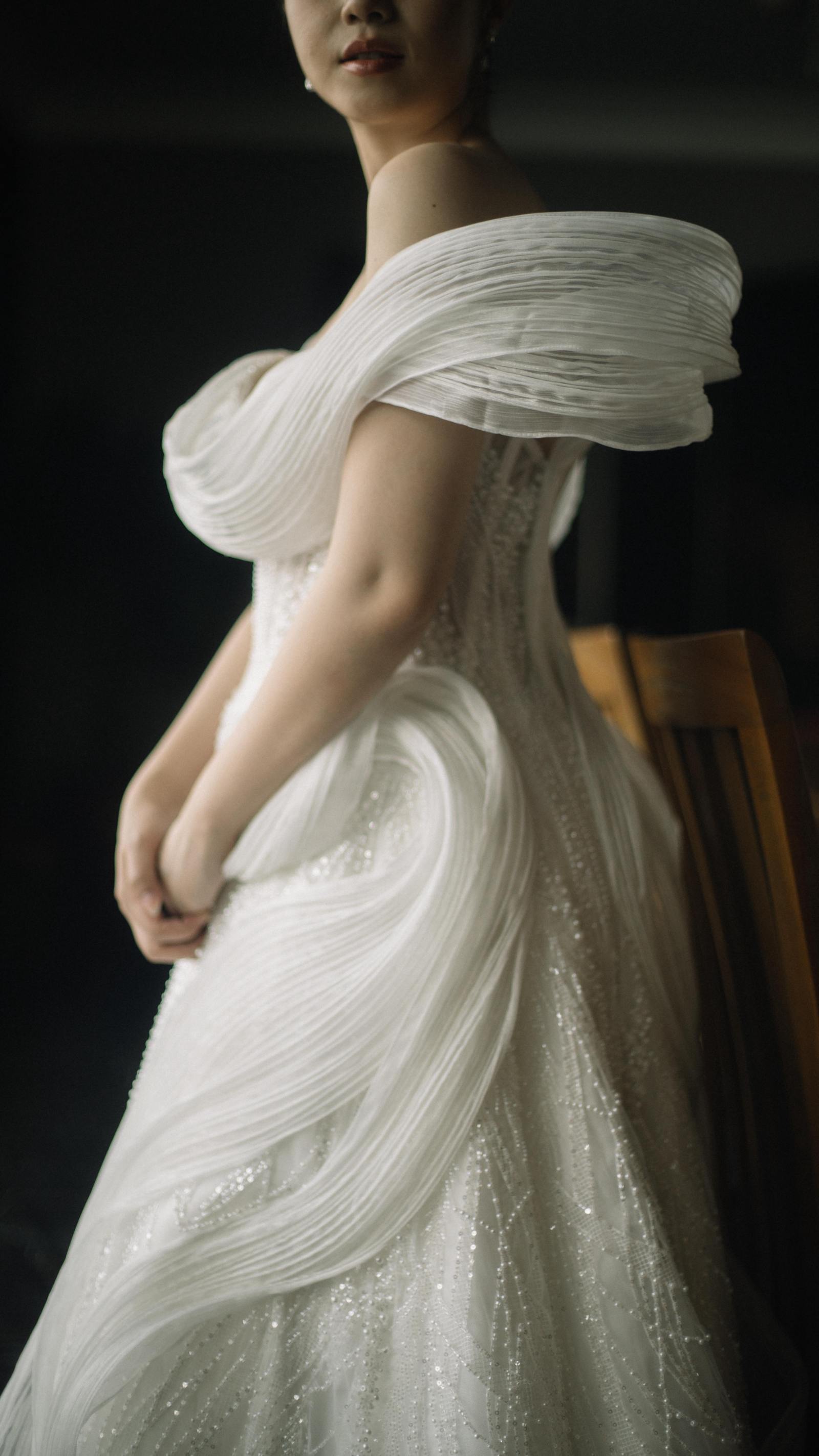 Close-up of hand-draped organza folds on a white bridal gown by CELRA
