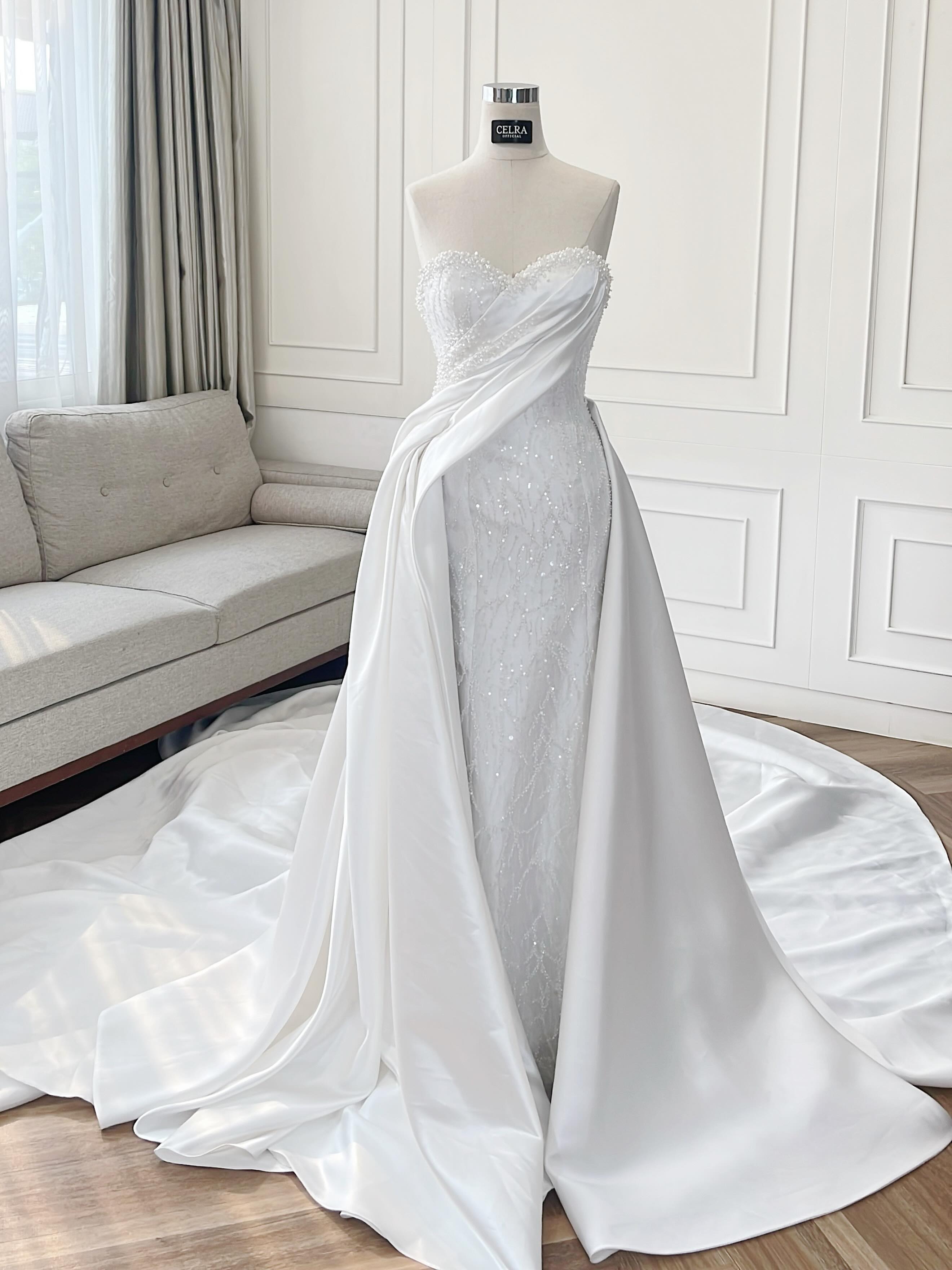 Strapless beaded wedding gown with draped satin overskirt by CELRA