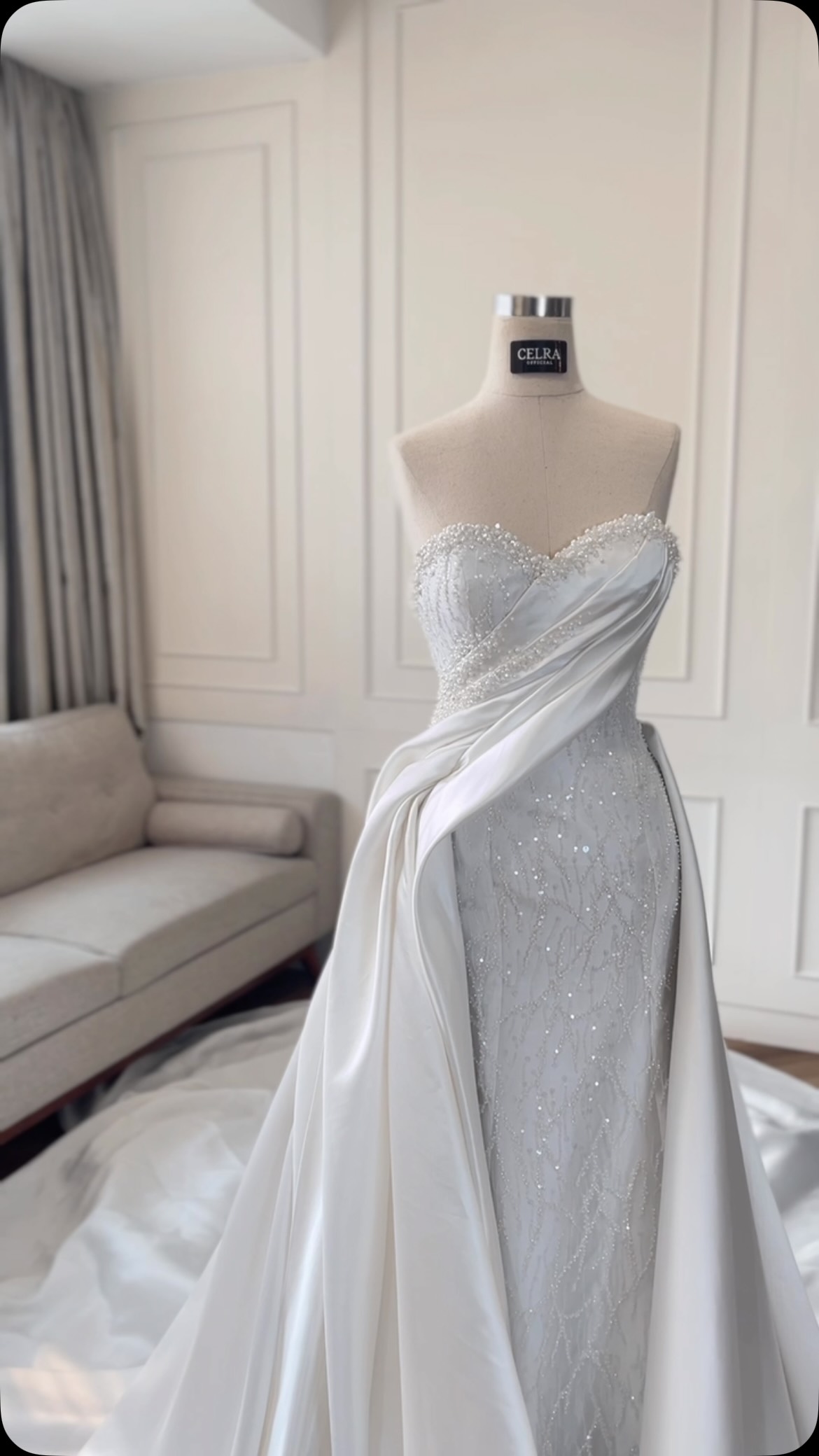 Detail of a draped satin overskirt over a beaded bodice by CELRA