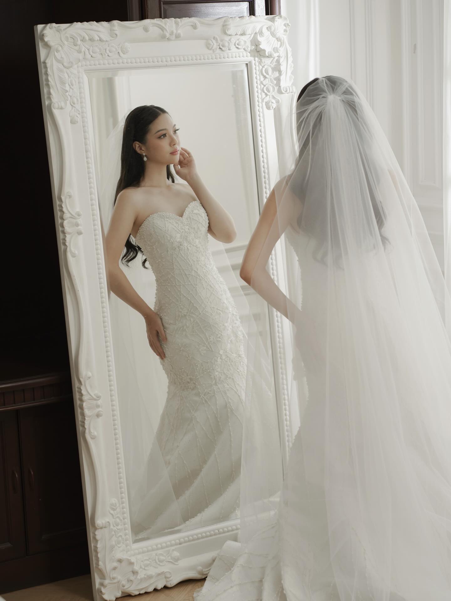 Bride with a cathedral veil reflected in an ornate mirror by CELRA