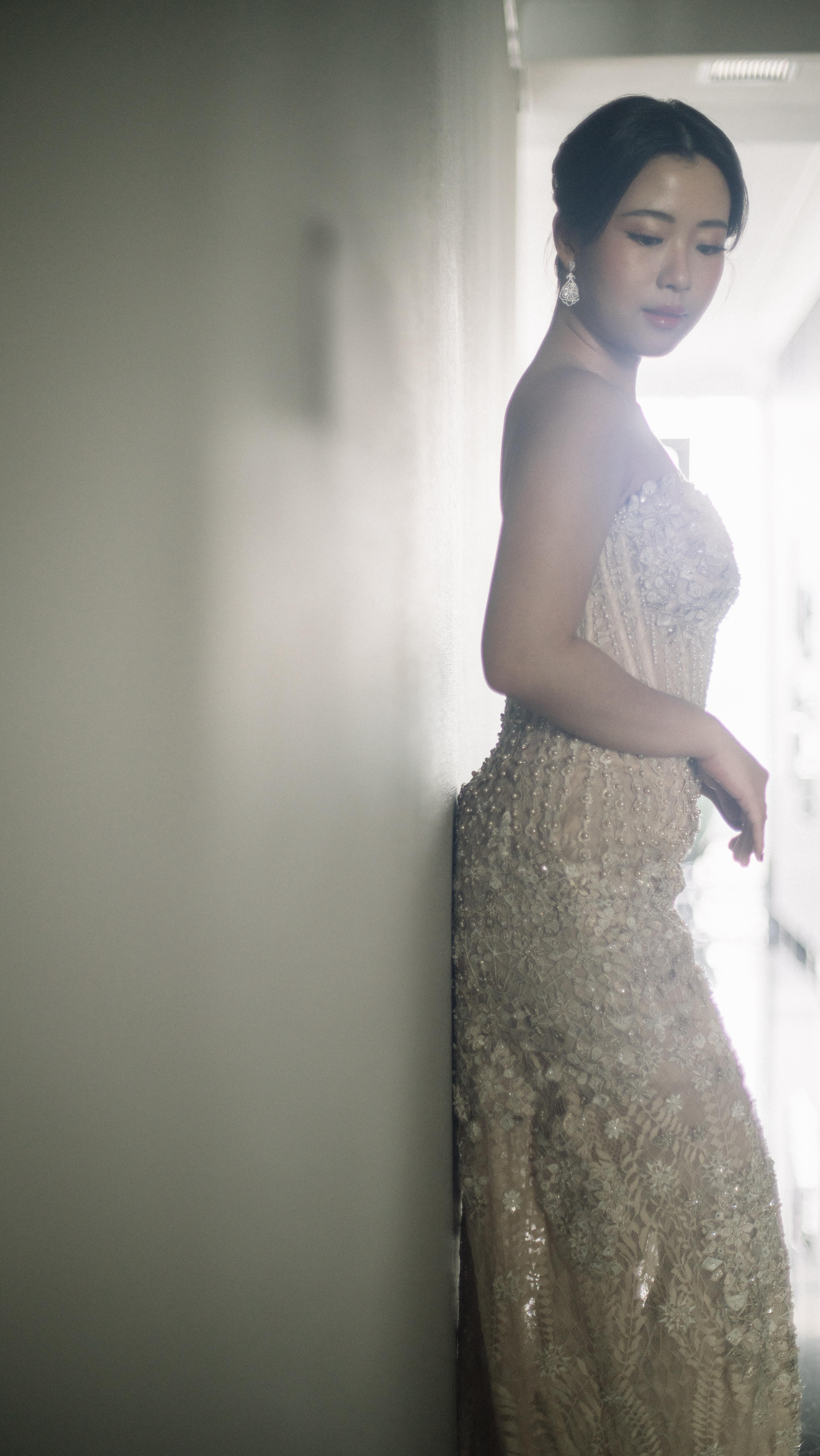 Sparkling champagne beaded gown near a sunlit window by CELRA
