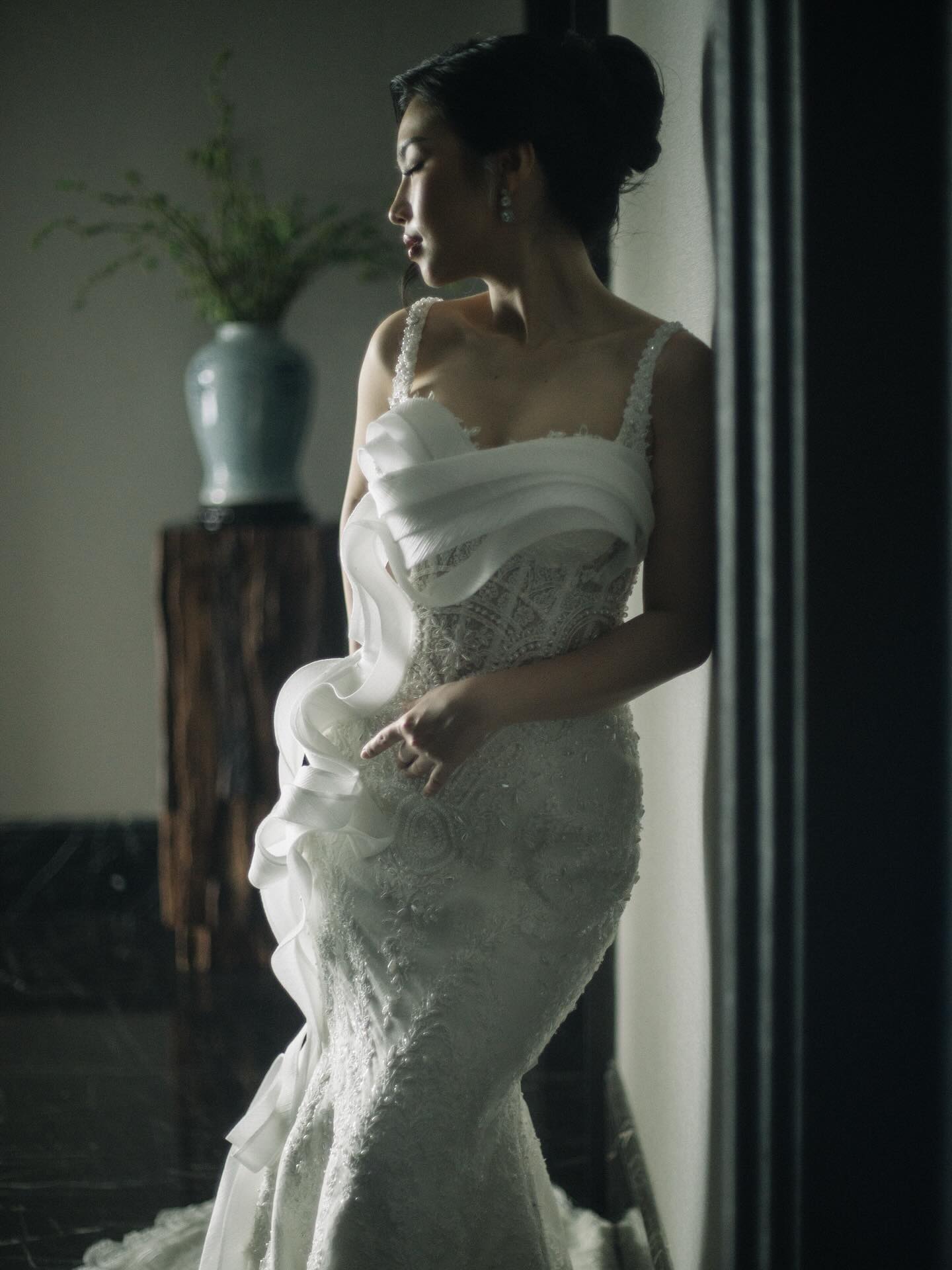 White mermaid gown with sculptural ruffles, side view by CELRA
