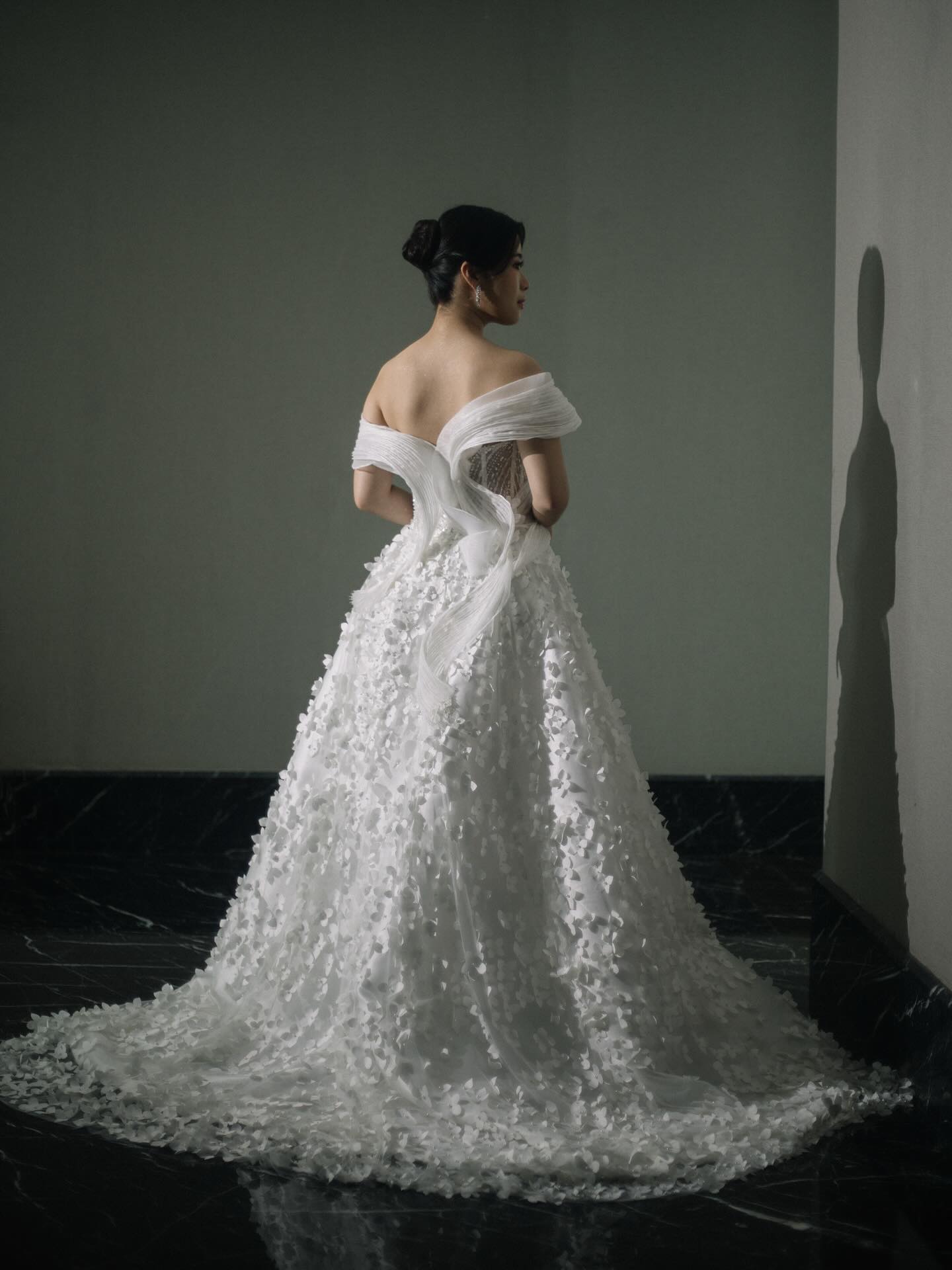 Off-shoulder ball gown with three-dimensional floral appliqué by CELRA