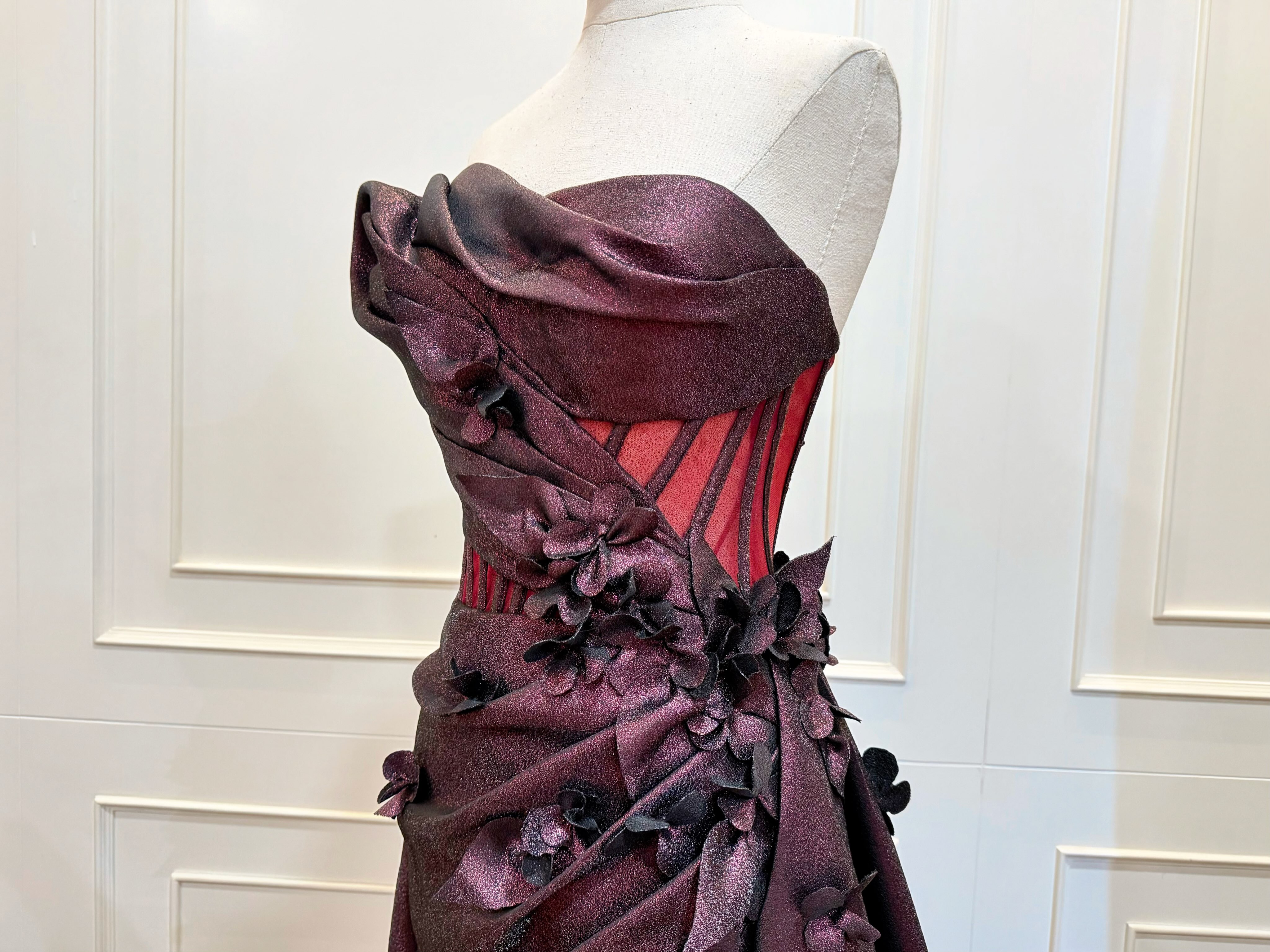 Burgundy gown with three-dimensional floral detail — CELRA.id rental